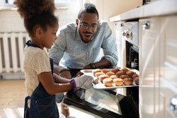 kid and dad cooking together in roundup of quotes about being a dad