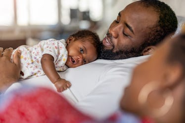 Father holding his newborn baby 
