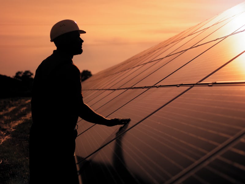 Assistance technical worker in uniform is checking an operation and efficiency performance of photov...