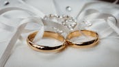 photo of two wedding rings in a ribbon