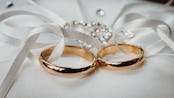 photo of two wedding rings in a ribbon