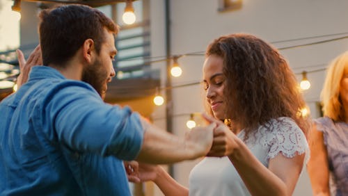 A couple is dancing outside in a garden together. These are the most compatible matches for Life Pat...