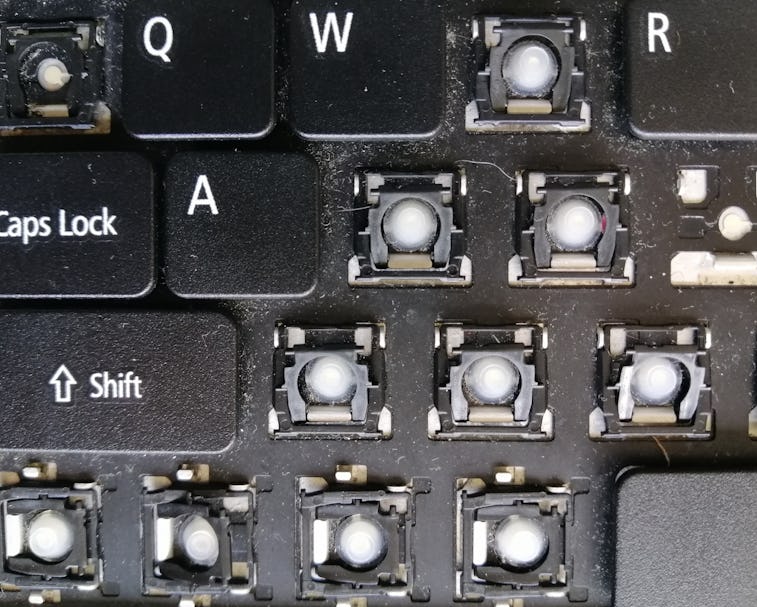 close up of a dirty and broken laptop keyboard