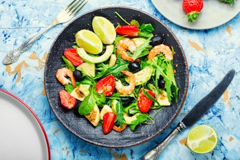 Fresh summer salad with prawn,strawberry,avocado,lime and olive.Summer salad,healthy eating
