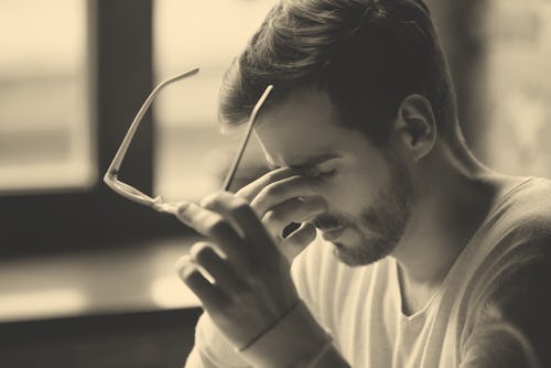 Close up of tired male take off glasses massage eyes feel fatigue suffering from strong headache, ex...