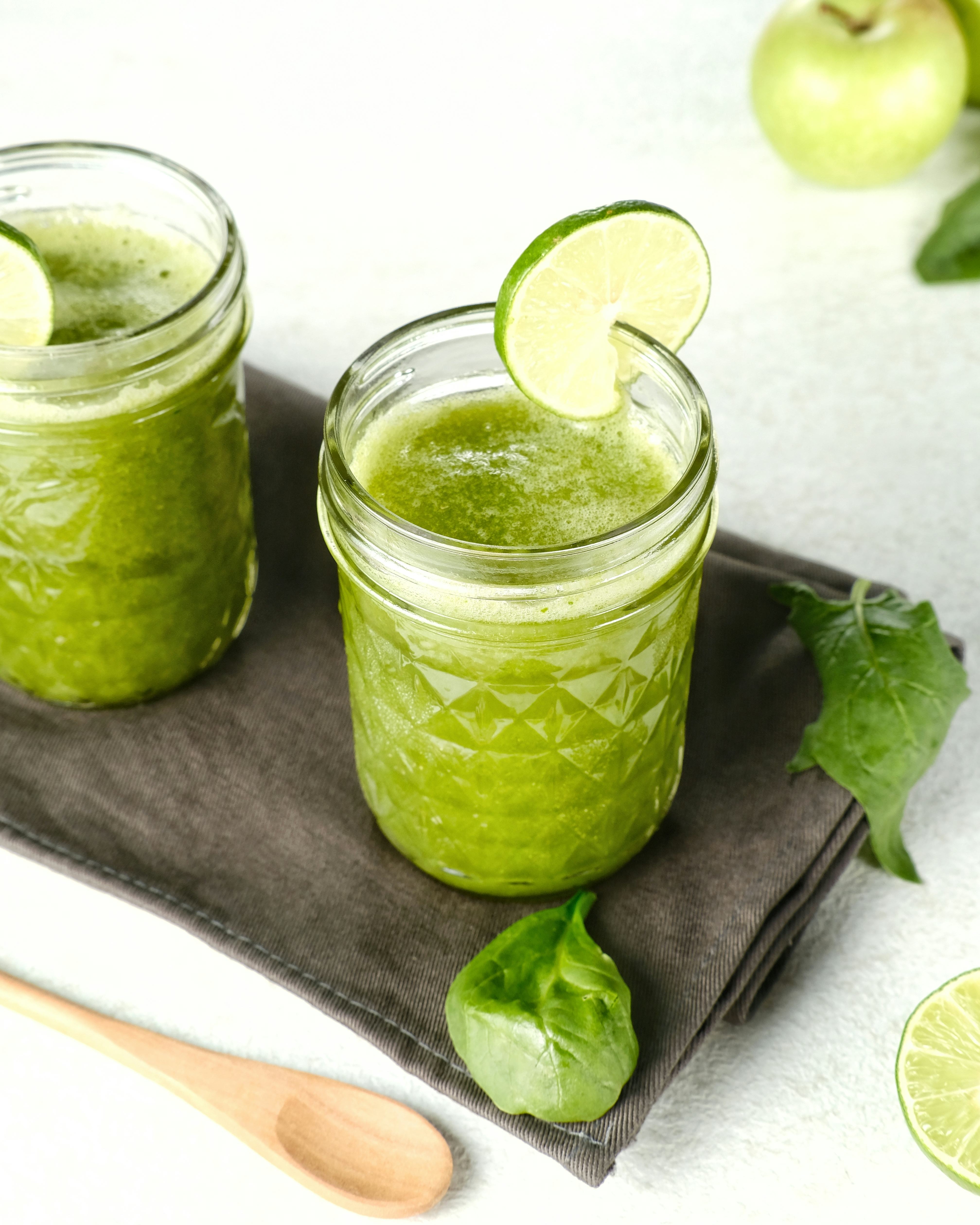 Homemade green smoothie (detailed close up shot; selective focus). Mason jar filled with spinach hor...