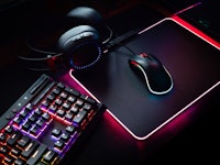 gamer workspace concept, top view a gaming gear, mouse, keyboard with RGB Color, joystick, headset, ...