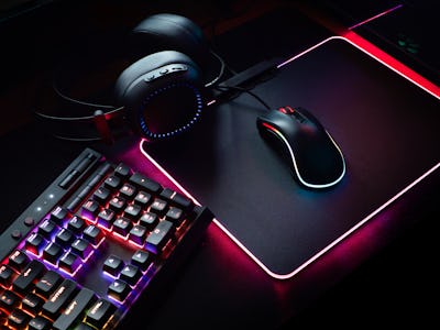 gamer workspace concept, top view a gaming gear, mouse, keyboard with RGB Color, joystick, headset, ...