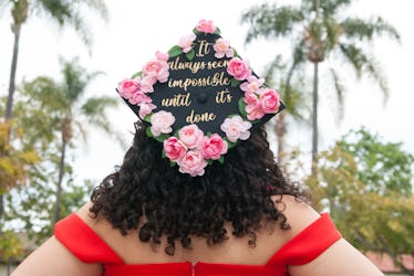 For grad cap inspo, a woman wears a homemade graduation cap that's matching with her best friend.