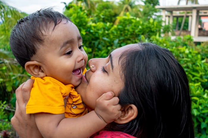 mom cuddling baby boy, boy names that start with o