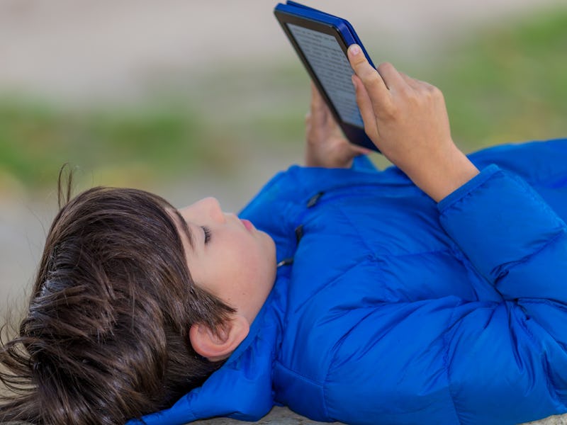 Young boy reading an ebook.