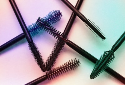 Assortment of brushes of black mascara texture