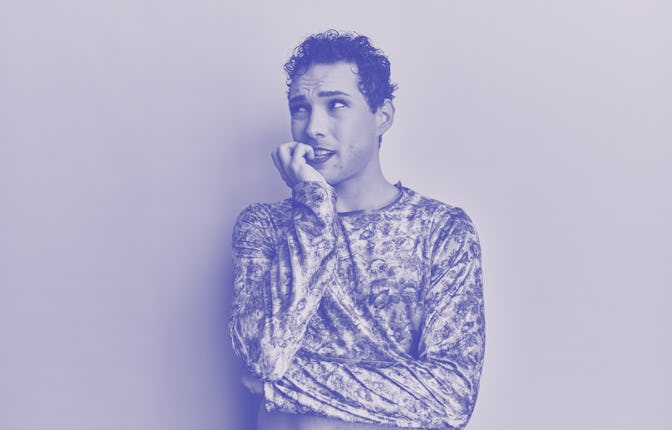 Handsome man wearing make up wearing fashion clothes looking stressed and nervous with hands on mout...