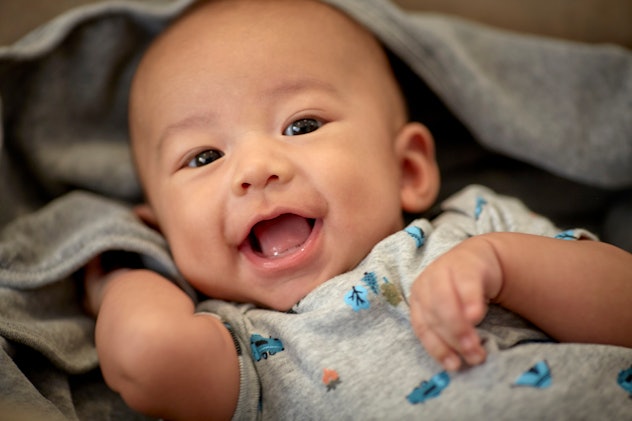 Cute 3 month old baby boy with a name that starts with O smiling for the camera.