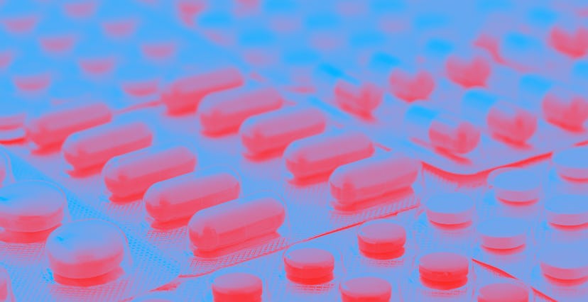 Heap of medical pills in white, blue and other colors. Pills in plastic package. Concept of healthca...