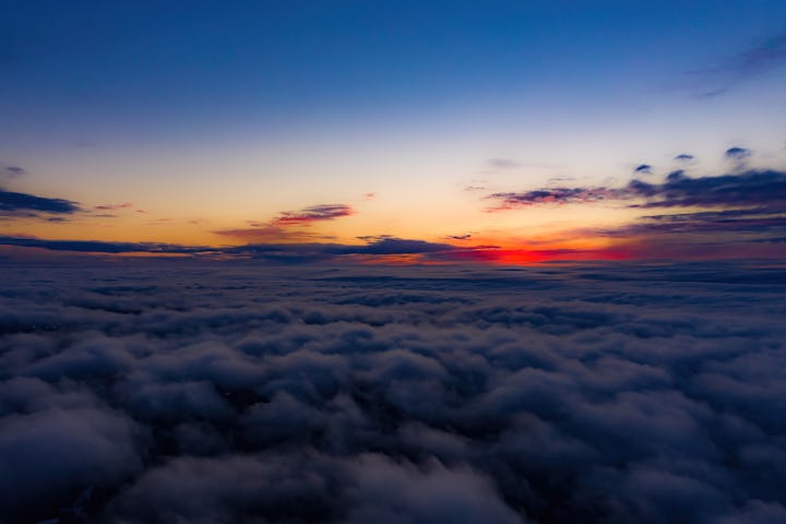 Aerial sunset view over the Blue Ridge Mountains from the cockpit of a private aircraft. Sky with cl...