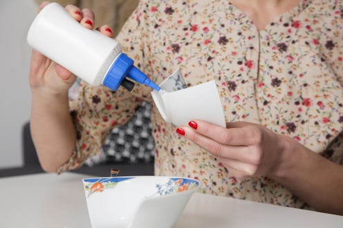 Woman repairing broken bowl using glue and brush. Serie of photos.
