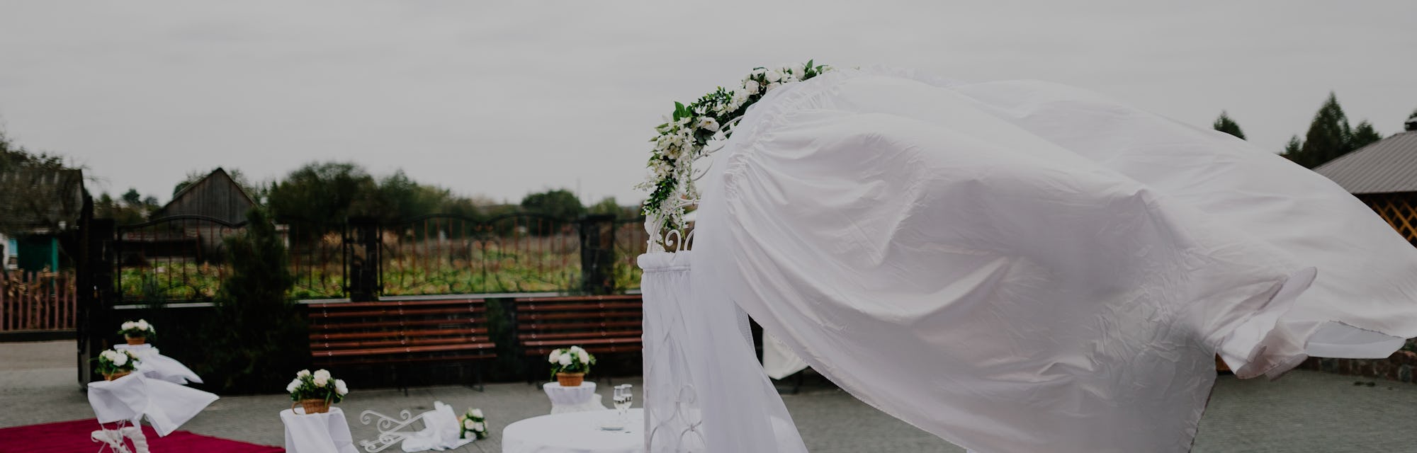 Detail of wedding gazebo on a backyard before or after the wedding ceremony, white wedding arch deco...