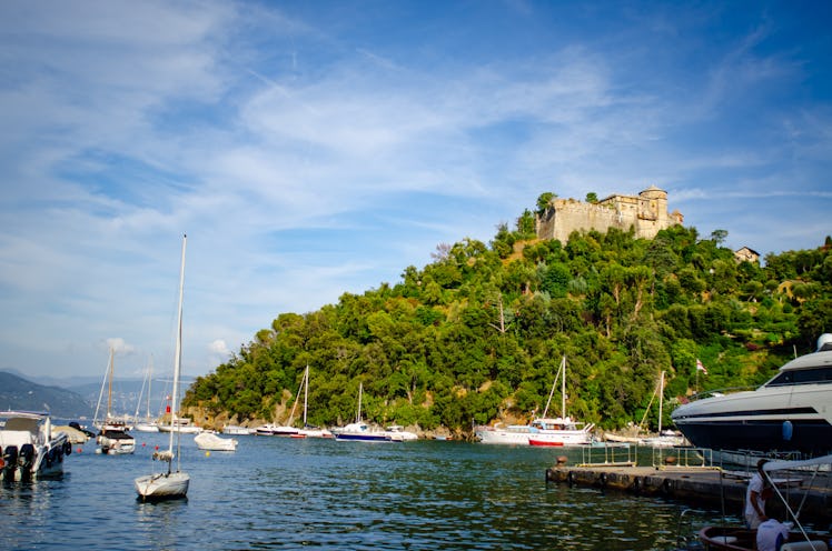 castello brown landscape in portofino with boats in harbour, a view from Kourtney Kardashian and Tra...