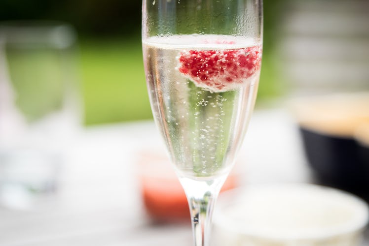 A glass of champagne with strawberry, which is a Memorial Day recipe for drinks.
