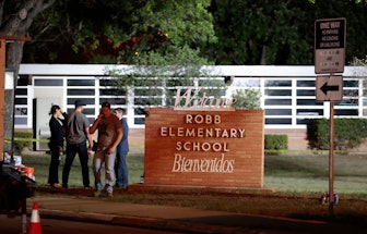 Police and investigators continue to work at the scene of a mass shooting at the Robb Elementary Sch...