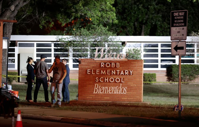 Police and investigators continue to work at the scene of a mass shooting at the Robb Elementary Sch...
