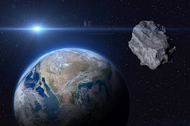 Planet Earth and big asteroid in the space. Potentially hazardous asteroids (PHAs). Asteroid in oute...