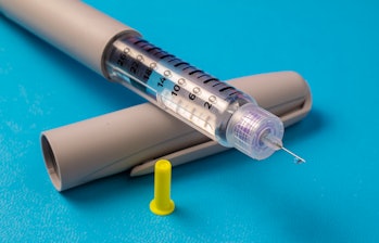 Insulin pen injector.  Insulin pen fill with needle on white background. Diabetes Day.