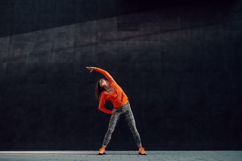 How to do a wide leg side reach stretch.