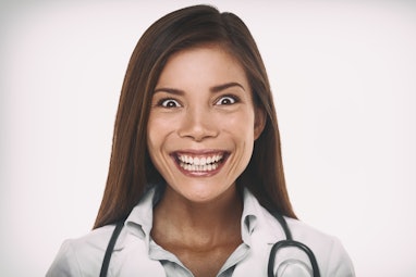 Evil smile mean psychopath doctor concept. Scary crazy Asian professional portrait woman smiling wit...