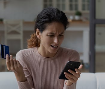 Access denied. Angry hispanic woman unable to make payment via smartphone scold mobile banking servi...