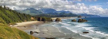 View of Cannon Beach in Oregon with Haystack Rock in the background, which is one of the summer vaca...