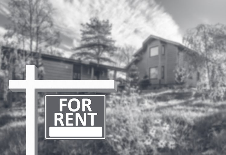 'For rent' sign next to a large house.