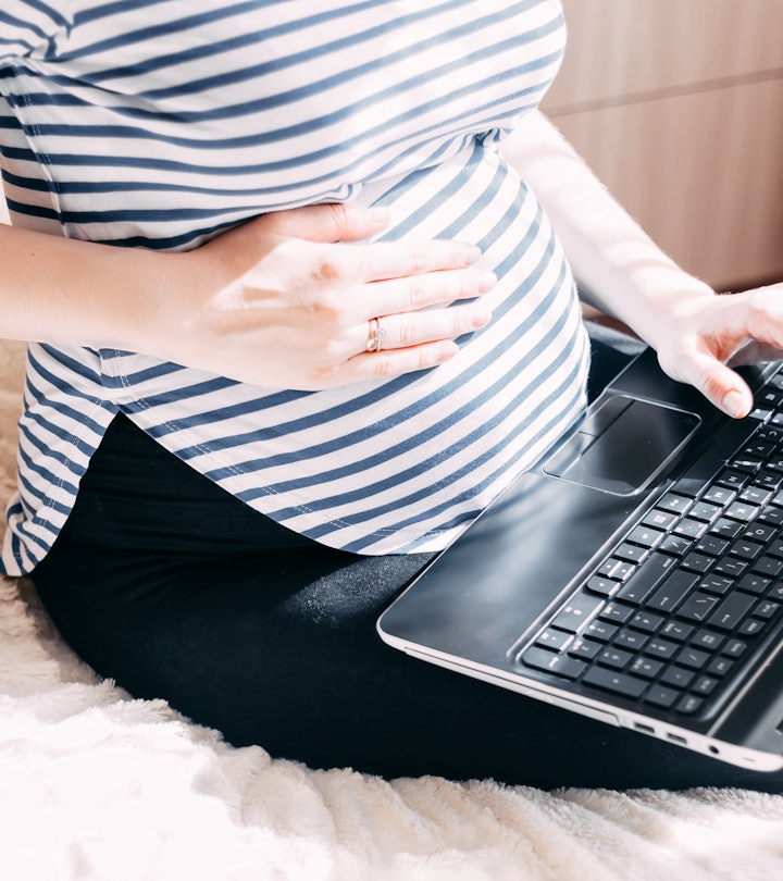 Pregnant woman working on laptop. Cropped image of pregnant businesswoman typing something on laptop...