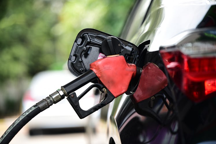 A car gets gas pumped into it at a gas station