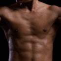 Sweat. Closeup of a strength fitness body with sweat. Fit young man with beautiful torso. Bodybuilde...