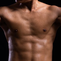 Sweat. Closeup of a strength fitness body with sweat. Fit young man with beautiful torso. Bodybuilde...