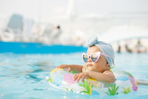 little girl in pool wearing sunglasses, summer baby girl names