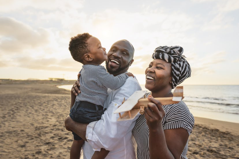 Happy African family having fun on the beach during summer vacation, summer baby boy names