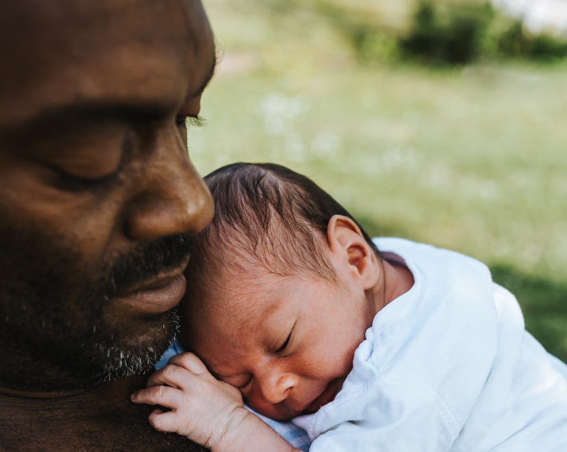 Dad holding baby, first father's day instagram captions