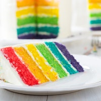 A slice of rainbow cake is the perfect rainbow dessert to celebrate Pride month.