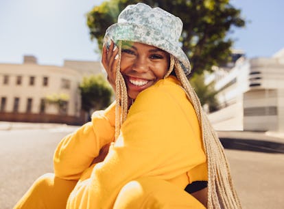 A happy woman uses summer solstice captions for sunny Instagram pics.