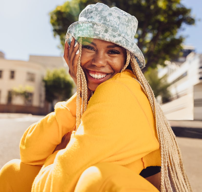 A happy woman uses summer solstice captions for sunny Instagram pics.