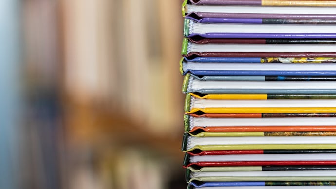 A stack of colorful books close up. A stack of multi-colored books close-up. View of the spine of th...