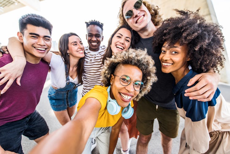 Happy friends taking group selfie think of summer solstice 2022 captions for Instagram pics.