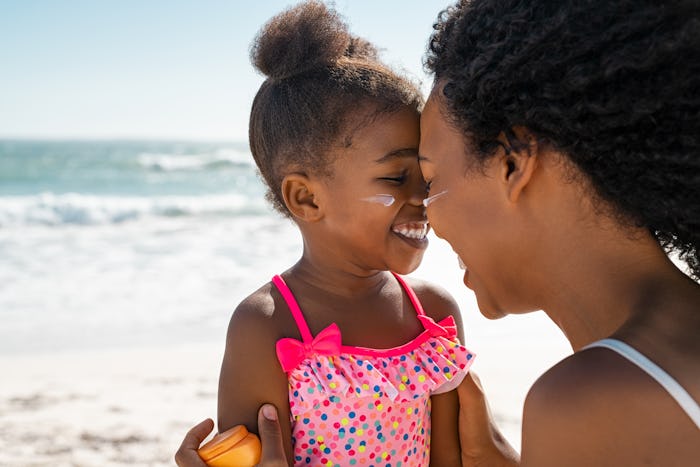 Photo of a Black mother and baby girl on the beach in a story of baby girl names starting with A.