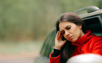 Women with Severe Headache Suffering from Motion Sickness - Girl in a pulled over automobile trying ...