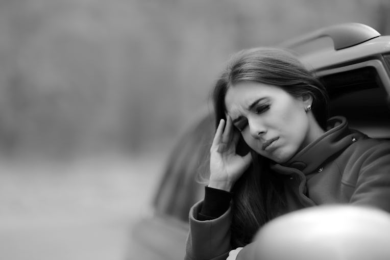 Women with Severe Headache Suffering from Motion Sickness - Girl in a pulled over automobile trying ...