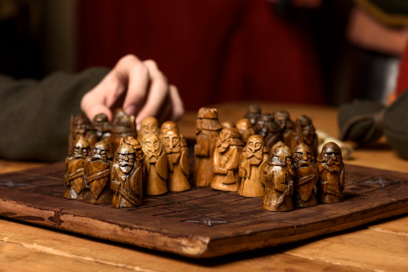 Wooden Viking chess hnefatafl on a wooden carved board made of dark wood, handmade