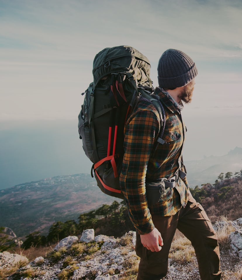 Man traveling with backpack hiking in mountains Travel Lifestyle success concept adventure active va...